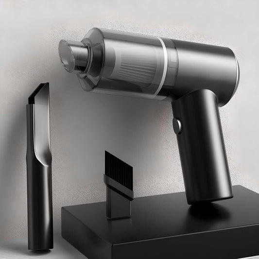 Silver handheld vacuum cleaner with attachments on a gray background